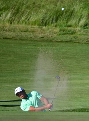 Brooks Koepka blasts from the No. 14 bunker during the final round of the 117th U.S. Open golf tournament at Erin Hill golf course on June 17, 2017, in Erin, Wisconsin.  WIS20170618559 KEVINxDIETSCH