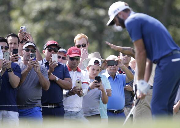 Fans holding mobile phones record Dustin Johnson on the second hole tee box in the final round of The Northern Trust golf championship at the Glen Oaks Club in Old Westbury, New York on August 27, 2017. Glen Oaks Club is hosting THE NORTHERN TRUST for the first time.  NYP20170827111 JOHNxANGELILLO