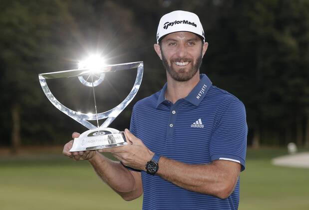 Dustin Johnson holds the championship trophy on the 18th green after he makes a birdie on the first playoff hole in his playoff against Jordan Spieth in the final round of The Northern Trust golf championship at the Glen Oaks Club in Old Westbury, New York on August 27, 2017. Johnson wins The Northern Trust with a score of 13 under par.  NYP20170827118 JOHNxANGELILLO