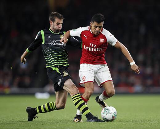 Arsenal s Alexis Sanchez tussles with Doncaster s Matty Blair during the Carabao Cup Third Round match at the Emirates Stadium, London. Picture date 20th September 2017. Picture credit should read: David Klein Sportimage EDITORIAL USE ONLY. No use with unauthorised audio, video, data, fixture lists, club league logos or live services. Online in-match use limited to 120 images, no video emulation. No use in betting, games or single club league player publications.