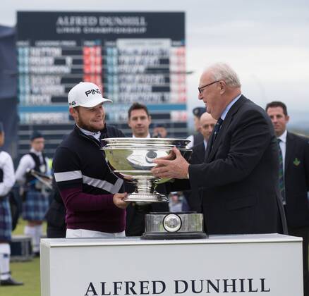 8th October 2017, Old Course, St Andrews, Scotland; Alfred Dunhill Links Championship, final round; England& x2019;s Tyrrell Hatton is presented with the Alfred Dunhill Kinks trophy by Sir Michael Bonallack after his -24 carded win on the Old Course, St Andrews  ActionPlus11939299