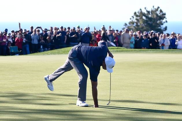January 26, 2018 - San Diego, California, United States - Tiger Woods picks up his birdie putt on the 9th green during the second round of the 2018 Farmers Insurance Open at Torrey Pines GC. Golf 2018: Farmers Insurance Open - Round 2 - ZUMAw109 20180126_zap_w109_055 Copyright: xDebbyxWongx