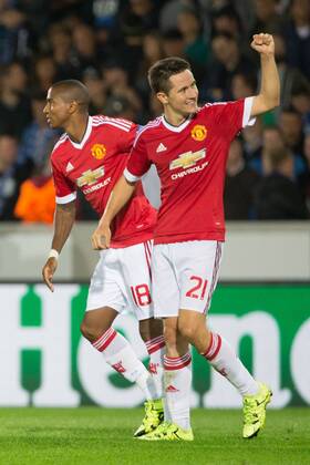 - BRUGGE, BELGIUM: Manchester s Ander Herrera (R) celebrates with his teammate Ashley Young after scoring during a soccer game between Belgian first league team Club Brugge KV and British club Manchester United ManU FC in Brugge, Wednesday 26 August 2015, the return game of the play-offs of the UEFA Champions League competition. Manchester United won the first leg 3-1. KURTxDESPLENTER  x84639070x
