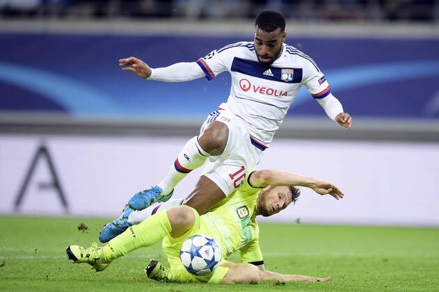 - GENT, BELGIUM: Lyon s Alexandre Lacazette and Gent s Lasse Nielsen fight for the ball during the first game in the group stage of the Uefa Champions League competition, in group H, between Belgian first league soccer team KAA Gent and Olympique Lyon, in Gent, Wednesday 16 September 2015. YORICKxJANSENS x85280468x