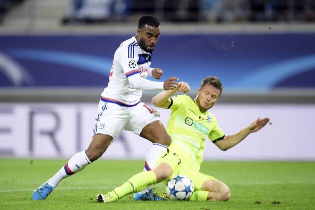 - GENT, BELGIUM: Lyon s Alexandre Lacazette and Gent s Lasse Nielsen fight for the ball during the first game in the group stage of the Uefa Champions League competition, in group H, between Belgian first league soccer team KAA Gent and Olympique Lyon, in Gent, Wednesday 16 September 2015. YORICKxJANSENS x85280474x