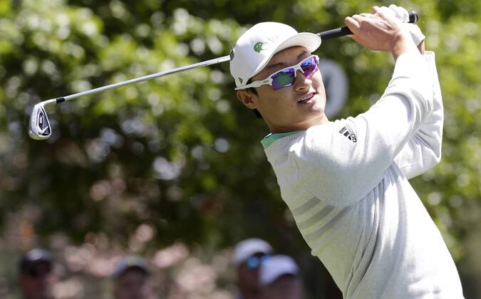 Li Haotong of China hits his tee shot on the 4th hole in the 1st round of the 2018 Masters Tournament at the Augusta National Golf Club in Augusta, Georgia, on April 5, 2018.  AUG20180405153 JOHNxANGELILLO