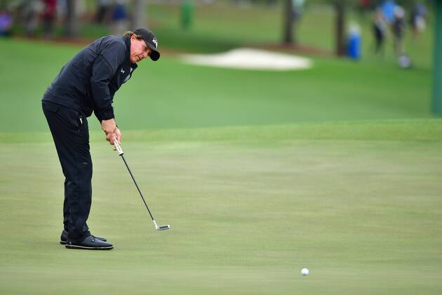 Phil Mickelson putts on the 18th green during the third round of the 2018 Masters Tournament at the Augusta National Golf Club in Augusta, Georgia, on April 7, 2018.  AUG20180407315 KEVINxDIETSCH