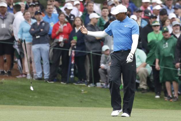 Tiger Woods tosses his club after he hits his approach shot to hole 15in the 3rd round of the 2018 Masters Tournament at the Augusta National Golf Club in Augusta, Georgia, on April 7, 2018.  AUG20180407114 JOHNxANGELILLO