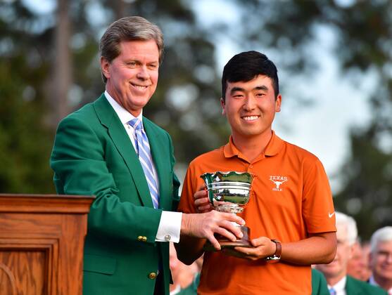 Augusta National Chairman Fred Ridley presents Doug Ghim with the low amateur trophy at the 2018 Masters Tournament at the Augusta National Golf Club in Augusta, Georgia, on April 8, 2018.  AUG20180408328 KEVINxDIETSCH