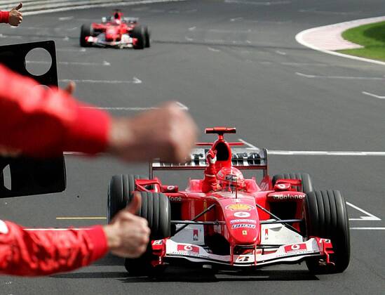 BRU455 - - FRANCORCHAMPS, BELGIUM : German Michael Schumacher celebrates on the finish line of the Belgian Formula One Grand Prix, Sunday 29 August 2004, on the race track of Spa-Francorchamps. Finnish Kimi Raikkonen won the race and Michael Schumacher got World Champion for the 7th time. POOL-FRANCOISxLENOIR  x2141461x