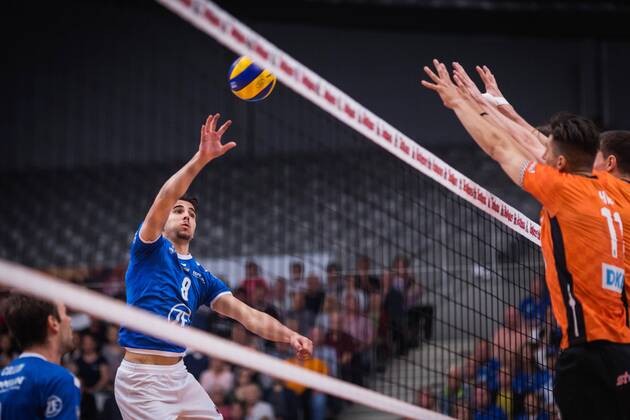 Friedrichshafen Germany 26 04 2018 Martin Atanasov Friedrichshafen 8 against the block from Adam White BR Volleys 11 and Graham Vigrass BR Volleys 8 in the Playoff Final Game 1 of the Volleyball Bundesliga between VfB Friedrichshafen and the Berlin Recycling Volleys