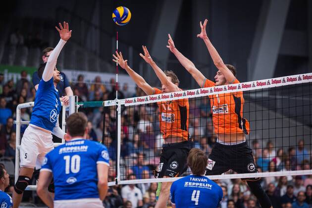 Friedrichshafen Germany 26 04 2018 David Sossenheimer Friedrichshafen 5 against the Paul Carroll block BR u200b u200bVolleys 12 and Aleksandar Okolic BR Volleys 1 in the Playoff Final Game 1 of the Volleyball Bundesliga between VfB Friedrichshafen and the Berlin Recycling Volleys