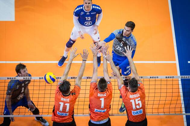 Berlin Germany 29 04 2018 David Sossenheimer Friedrichshafen 5 against the block from Adam White BR Volleys 11 Aleksandar Okolic BR Volleys 1 and Russell Kyle BR Volleys 15 at Playoff Final Game 2 of the Volleyball Bundesliga between Berlin Recycling Volleys and VfB Friedrichshafen