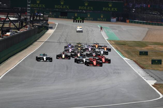 8th July 2018, Silverstone Circuit, Silverstone, England; British Formula One Grand Prix, Race Day; Scuderia Ferrari, Sebastian Vettel leads into Turn 1 ahead of Bottas after Lewis Hamilton has a poor start  ActionPlus12045458 Octane