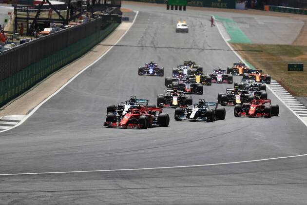 8th July 2018, Silverstone Circuit, Silverstone, England; British Formula One Grand Prix, Race Day; Scuderia Ferrari, Sebastian Vettel leads into Turn 1 ahead of Bottas after Lewis Hamilton has a poor start  ActionPlus12045461 Octane