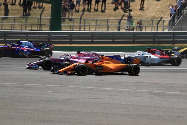 8th July 2018, Silverstone Circuit, Silverstone, England; British Formula One Grand Prix, Race Day; Sahara Force India, Sergio Perez locks up into Turn 1 and comes close to McLaren, Fernando Alonso as they go off the racing line  ActionPlus12045473 Octane