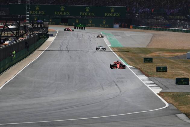 8th July 2018, Silverstone Circuit, Silverstone, England; British Formula One Grand Prix, Race Day; Scuderia Ferrari, Sebastian Vettel leads on lap 2 ahead of Bottas  ActionPlus12045478 Octane