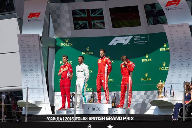 8th July 2018, Silverstone Circuit, Silverstone, England; British Formula One Grand Prix, Race Day; The podium presentation, first Scuderia Ferrari driver Sebastian Vettel, second Mercedes AMG Petronas Motorsport driver Lewis Hamilton and third Scuderia Ferrari driver Kimi Raikkonen  ActionPlus12045568 TimxWilliams