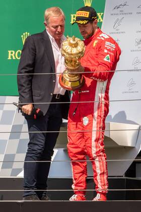 8th July 2018, Silverstone Circuit, Silverstone, England; British Formula One Grand Prix, Race Day; Scuderia Ferrari driver Sebastian Vettel looks at the winners trophy with Sky TV presenter Martin Brundle  ActionPlus12045554 TimxWilliams