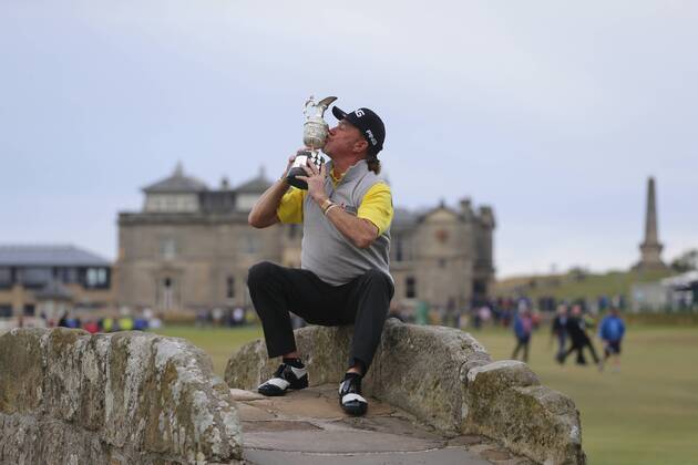 29th July 2018, Old Course at St Andrews, St Andrews, Scotland; The 2018 Senior Open Golf Championships, 4th round; This year s winner Miguel Angel Jimenez (ESP) poses with the Senior Open trophy on the Swilken Bridge on the 18th hole of the Old course  ActionPlus12051759 AlanxMartin