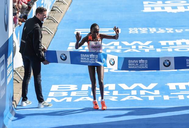 (180916) -- BERLIN, Sept. 16, 2018 -- Kenya s Gladys Cherono (R) crosses the finishing line during the Berlin Marathon 2018 in Berlin, capital of Germany, on Sept. 16, 2018. The Berlin Marathon 2018 kicked off in Berlin on Sunday. Eliud Kipchoge from Kenya won the men s title with a new world record of 2:01:39. Women s title fell on Kenya s Gladys Cherono with a result of 2:18:11. ) (SP)GERNAMY-BERLIN-BERLIN MARATHON 2018 ShanxYuqi 