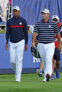 Tiger Woods (L) and Patrick Reed walk towards the fairway after hitting their opening shots on the first tee at the start of the Ryder Cup at Le Golf National in Guyancourt near Paris on September 28, 2018. Team USA will compete against Team Europe in the three-day tournament.  PAR20180928088 DAVIDxSILPA