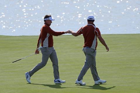 Ian Poulter (L) fist bumps teammate Jon Rahm on the 15th green on day two of the Ryder Cup at Le Golf National in Guyancourt near Paris on September 29, 2018. Poulter and Rahm lost their match to Jordan Spieth and Justin Thomas 2 & 1.  PAR20180929026 DAVIDxSILPA