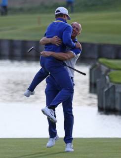 Alex Noren (R) and Thorbjorn Olesen celebrate after Noren made a long putt on the 18th hole at the Ryder Cup at Le Golf National in Guyancourt near Paris on September 30, 2018. Team Europe defeated Team USA 17.5 to 10.5 to hand the Americans their sixth straight loss on foreign soil.  PAR20180930063 DAVIDxSILPA