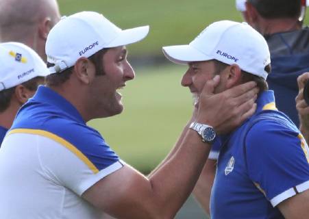 Jon Rahm (L) and Sergio Garcia celebrate after Team Europe clinches the Ryder Cup at Le Golf National in Guyancourt near Paris on September 30, 2018. Team Europe defeated Team USA 17.5 to 10.5 to hand the Americans their sixth straight loss on foreign soil.  PAR20180930067 DAVIDxSILPA