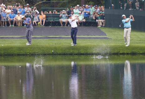 Tiger Woods, Justin Thomas and Fred Couples skip balls across the water on the 16th green when they practice on the Monday before the 2019 Masters Tournament at Augusta National Golf Club in Augusta, Georgia, on April 8, 2019.  AUG20190408109 JOHNxANGELILLO