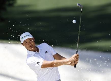 Li Haotong lines hits out of a bunker on the 10th green at practice on the Tuesday before the 2019 Masters Tournament at Augusta National Golf Club in Augusta, Georgia, on April 9, 2019.  AUG20190409109 JOHNxANGELILLO