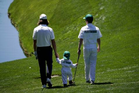 Tommy Fleetwood holds the hand of son Franklin Fleetwood at the Par 3 Contest on the Wednesday before the 2019 Masters Tournament at Augusta National Golf Club in Augusta, Georgia, on April 10, 2019.  AUG20190410736 JOHNxANGELILLO