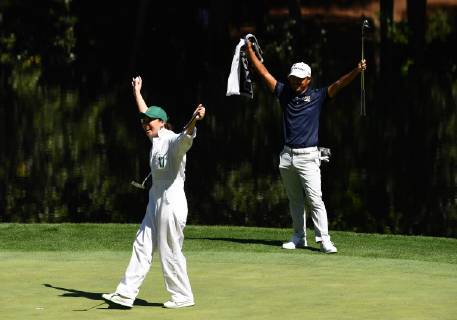 Satoshi Kodaira celebrates with his caddie when she makes a putt at the Par 3 Contest on the Wednesday before the 2019 Masters Tournament at Augusta National Golf Club in Augusta, Georgia, on April 10, 2019.  AUG20190410926 KEVINxDIETSCH