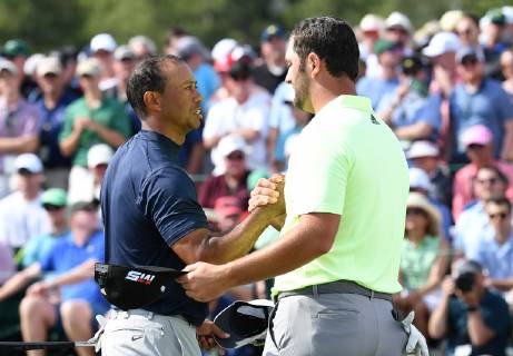 Jon Rahm of Spain shakes hands with Tiger Woods on the 18th green in the first round at the 2019 Masters Tournament at Augusta National Golf Club in Augusta, Georgia, on April 11, 2019.  AUG20190411811 KEVINxDIETSCH