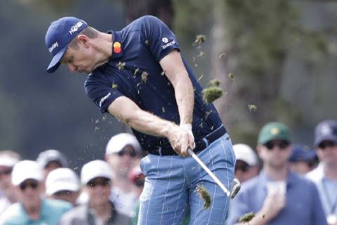 Justin Rose of the United Kingdom hits his approach shot to the first hole in the second round at the 2019 Masters Tournament at Augusta National Golf Club in Augusta, Georgia, on April 12, 2019.  AUG20190412106 JOHNxANGELILLO