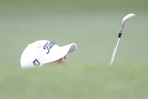 Justin Thomas hits out of a bunker on the first hole in the second round at the 2019 Masters Tournament at Augusta National Golf Club in Augusta, Georgia, on April 12, 2019.  AUG20190412107 JOHNxANGELILLO