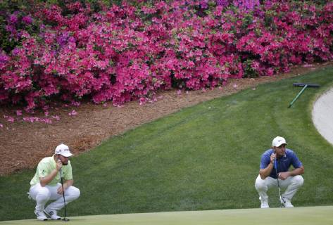 Francesco Molinari of Italy and Tyrrell Hatton line up putts on the 13th hole in the second round at the 2019 Masters Tournament at Augusta National Golf Club in Augusta, Georgia, on April 12, 2019.  AUG20190412126 JOHNxANGELILLO