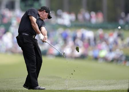 Phil Mickelson hits his approach shot to the 1st hole in the third round at the 2019 Masters Tournament at Augusta National Golf Club in Augusta, Georgia, on April 13, 2019.  AUG20190413901 JOHNxANGELILLO