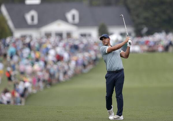 Brooks Koepka hits his approach shot to the 1st hole in the final round at the 2019 Masters Tournament at Augusta National Golf Club in Augusta, Georgia, on April 14, 2019.  AUG20190414905 JOHNxANGELILLO
