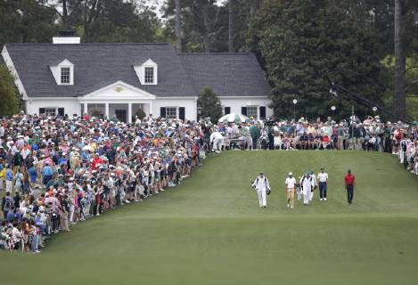 Francesco Molinari, Tiger Woods and Tony Finau walk to play a second shot after hitting their tee balls on the 1st hole in the final round at the 2019 Masters Tournament at Augusta National Golf Club in Augusta, Georgia, on April 14, 2019.  AUG20190414908 JOHNxANGELILLO
