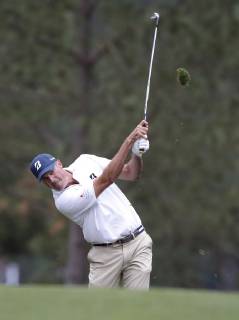 Matt Kuchar hits his approach shot on the 1st hole in the final round at the 2019 Masters Tournament at Augusta National Golf Club in Augusta, Georgia, on April 14, 2019.  AUG20190414904 JOHNxANGELILLO