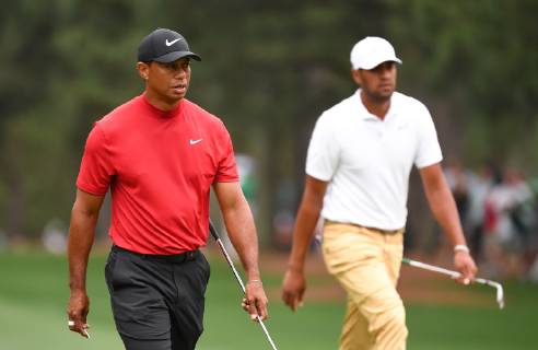 Tiger Woods walks with Tony Finau on the first fairway during the final round of the Masters Tournament at Augusta National Golf Club in Augusta, Georgia, on April 14, 2019.  AUG20190414315 KEVINxDIETSCH