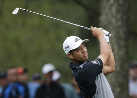 Xander Schauffele hits his approach shot on the 1st hole in the final round at the 2019 Masters Tournament at Augusta National Golf Club in Augusta, Georgia, on April 14, 2019.  AUG20190414914 JOHNxANGELILLO