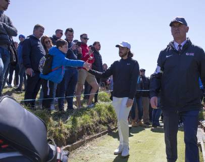 11th May 2019, Hillside Golf Club, Southport, England; Betfred British Masters, hosted by Tommy Fleetwood, day 3; Tommy Fleetwood (ENG) shakes hands with a young golf fan on his way to the tee at the 7th hole  ActionPlus12133920 DavidxBlunsden