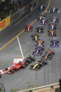Driver field of the Formula 1 Grand Prix in the Principality of Monaco shortly after the start at the end of the start home straight and before the Ste Devote curve, Cote dÂ Azur, Mediterranean Sea