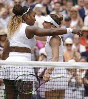 Tennis: Wimbledon championships Serena Williams (L) of the United States and Simona Halep of Romania meet at the net after their Wimbledon final on July 13, 2019.