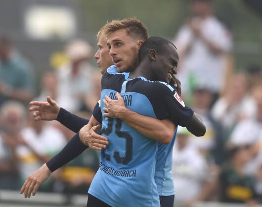 Test match Borussia Mönchengladbach SCO Angers France 27 07 2019 Famana Quizera embraces goalscorer Patrick Herrmann BMG , behind Oscar Wendt DFL REGULATIONS PROHIBIT ANY USE OF PHOTOGRAPHS AS IMAGE SEQUENCES AND OR QUASI VIDEO HM