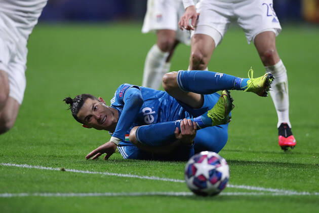 Juventus s Portuguese striker Cristiano Ronaldo holds his ankle after being fouled during the UEFA Champions League match at the Groupama Stadium, Lyon. Picture date: 26th February 2020. Picture credit should read: Jonathan Moscrop Sportimage EDITORIAL USE ONLY. No use with unauthorised audio, video, data, fixture lists, club league logos or live services. Online in-match use limited to 120 images, no video emulation. No use in betting, games or single club league player publications. SPI-0491-0022