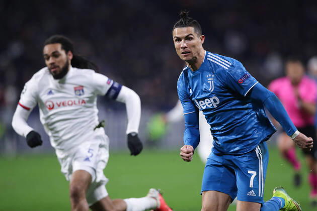Juventus s Portuguese striker Cristiano Ronaldo advances forwards followed by Lyon s Belgian defender Jason Denayer during the UEFA Champions League match at the Groupama Stadium, Lyon. Picture date: 26th February 2020. Picture credit should read: Jonathan Moscrop Sportimage EDITORIAL USE ONLY. No use with unauthorised audio, video, data, fixture lists, club league logos or live services. Online in-match use limited to 120 images, no video emulation. No use in betting, games or single club league player publications. SPI-0491-0023