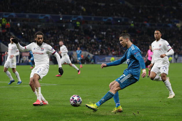 Juventus s Portuguese striker Cristiano Ronaldo crosses the ball as Lyon s Belgian defender Jason Denayer closes him down during the UEFA Champions League match at the Groupama Stadium, Lyon. Picture date: 26th February 2020. Picture credit should read: Jonathan Moscrop Sportimage EDITORIAL USE ONLY. No use with unauthorised audio, video, data, fixture lists, club league logos or live services. Online in-match use limited to 120 images, no video emulation. No use in betting, games or single club league player publications. SPI-0491-0062